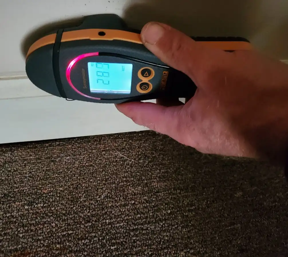 Moisture detection at baseboard during Storm Damage Restoration in Lake Worth Beach